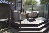 Stairs and composite deck with railings.