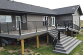 Stairs and composite deck with railings.